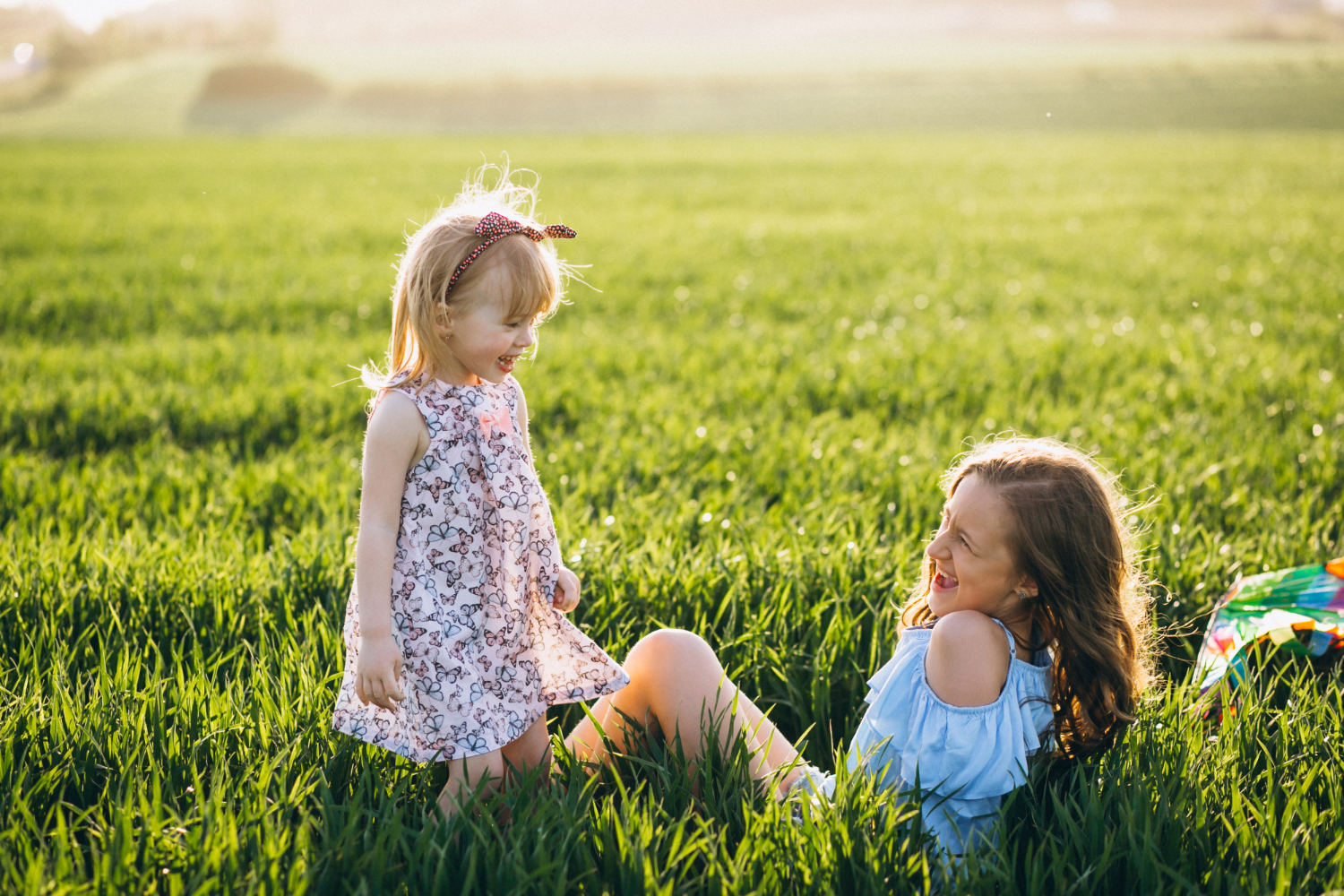 sisters playing on green grass